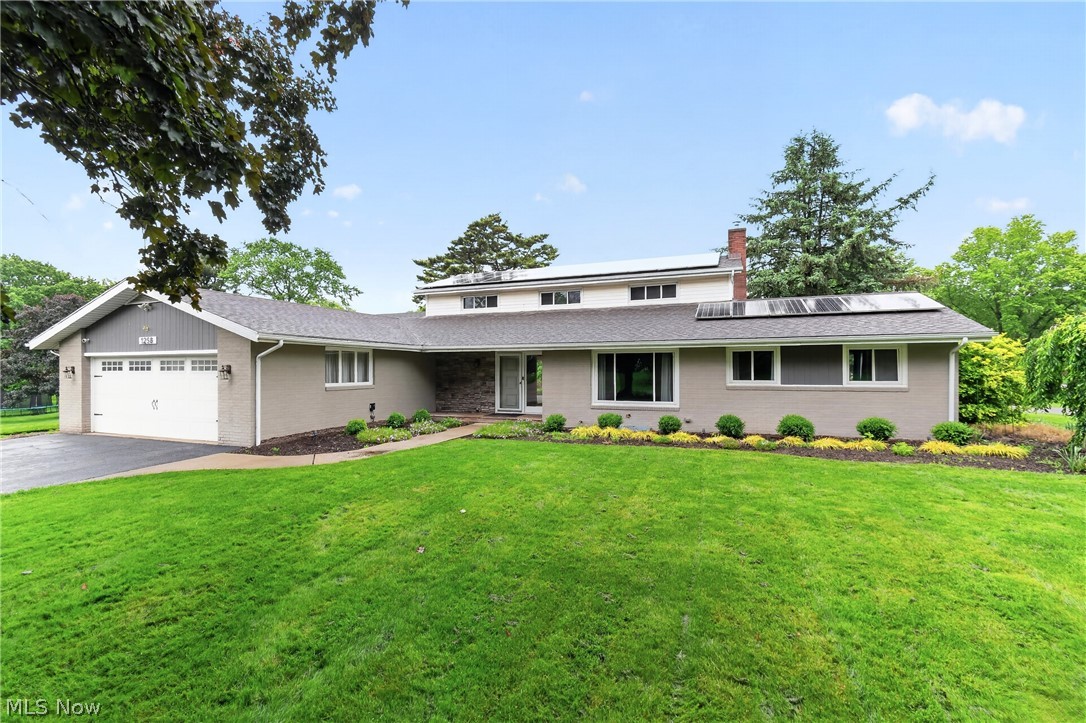 Discover this stunning four bedroom sprawling modern home nestled in NE Massillon’s prestigious Charity Rotch neighborhood. Thoughtfully designed, this residence seamlessly blends classic architectural charm with contemporary, energy-efficient features. Enjoy the benefits of solar roof panels that help significantly reduce energy costs while embracing sustainable living. The spacious living room is bathed in natural light thanks to an abundance of large windows, creating an inviting and airy atmosphere throughout. At the heart of the home, the beautifully updated kitchen features elegant granite countertops, sleek appliances, a wine fridge, and an oversized bar perfect for everyday living and entertaining alike. Its expansive layout offers ample space for culinary creativity and hosting large gatherings. Relax in the first-floor primary owner’s retreat featuring a generous walk-in closet and private en-suite bath complete with a beautifully tiled tub and shower, offering both comfort and style. The main level also includes an additional bedroom and a dedicated home office, ideal for guests or remote work. Upstairs, you’ll find two well-appointed bedrooms sharing a full bath with a tiled tub, providing privacy and versatility to fit a variety of lifestyle needs.
The partially finished walk-out basement adds additional living space with second fireplace (plummed for gas) and features a putting green area with direct access to the back patio; the perfect setup for entertaining or relaxing. Additional highlights include a two-car attached garage and a shed situated on an additional parcel, offering plenty of extra storage space. Experience timeless elegance paired with modern eco-friendly amenities in one of the area’s most sought-after neighborhoods. Updates include; HVAC and thermostat (2 years), tankless water heater, reverse osmosis, dishwasher 2026, many windows, gutters (2 years) slider door, outdoor lighting/electric added for hot tub and more.