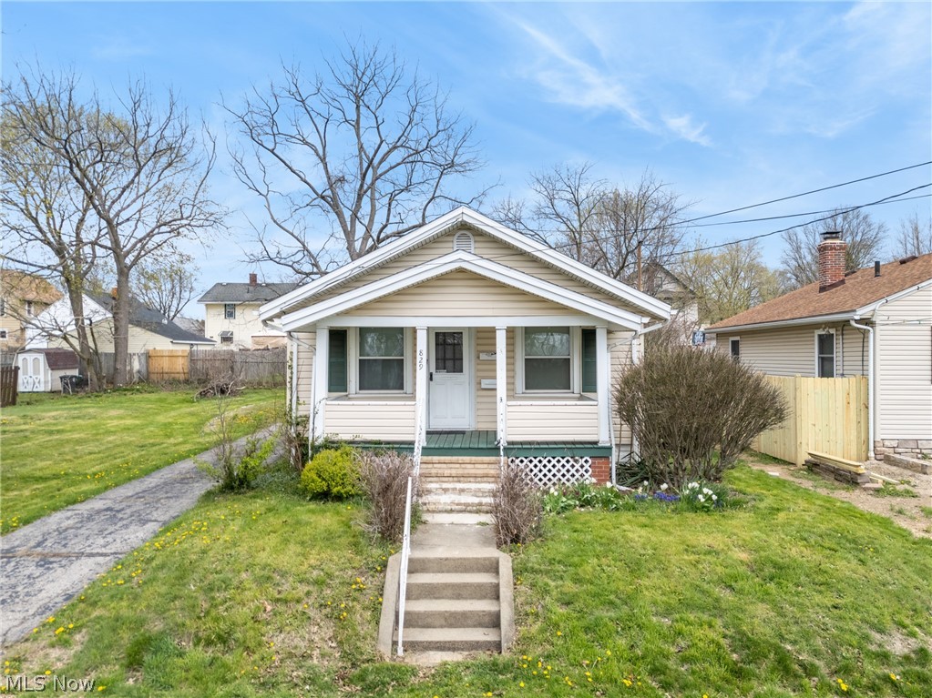 Welcome to this affordable, well-maintained, and spacious home nestled on two parcels in a peaceful Akron neighborhood! As you enter, you’ll be greeted by beautifully preserved original hardwood floors that flow throughout the home, exuding warmth and character. The elegant fireplace and historical window designs seamlessly blend modern sensibilities with traditional charm! The main floor features a generous living room that transitions into a formal dining area, ideal for hosting family gatherings and entertaining friends. The kitchen boasts ample storage and countertop space, accompanied by like-new appliances, all of which will remain with the home for the new owner! Convenience is key, with two bedrooms located on the main floor, along with a full bathroom, making this layout perfect for easy living. Descend into the basement for additional storage, where you'll find a versatile recreation room—perfect for a home office, workout space, or any hobbies you enjoy. Plus, the included laundry appliances make chores a breeze. The second full-bathroom on the lower level offers additional convenience and versatility! This property sits on two city lots, featuring a spacious yard, a private and sizable driveway, and an oversized detached garage that accommodates two vehicles along with your maintenance equipment and outdoor belongings. Recent updates include a newer air conditioning unit and hot water tank (installed in 2025), as well as a newer roof with plenty of life left! Don’t miss your chance to call this delightful home yours! Reach out to your favorite agent to schedule a showing today—this gem won’t last long!