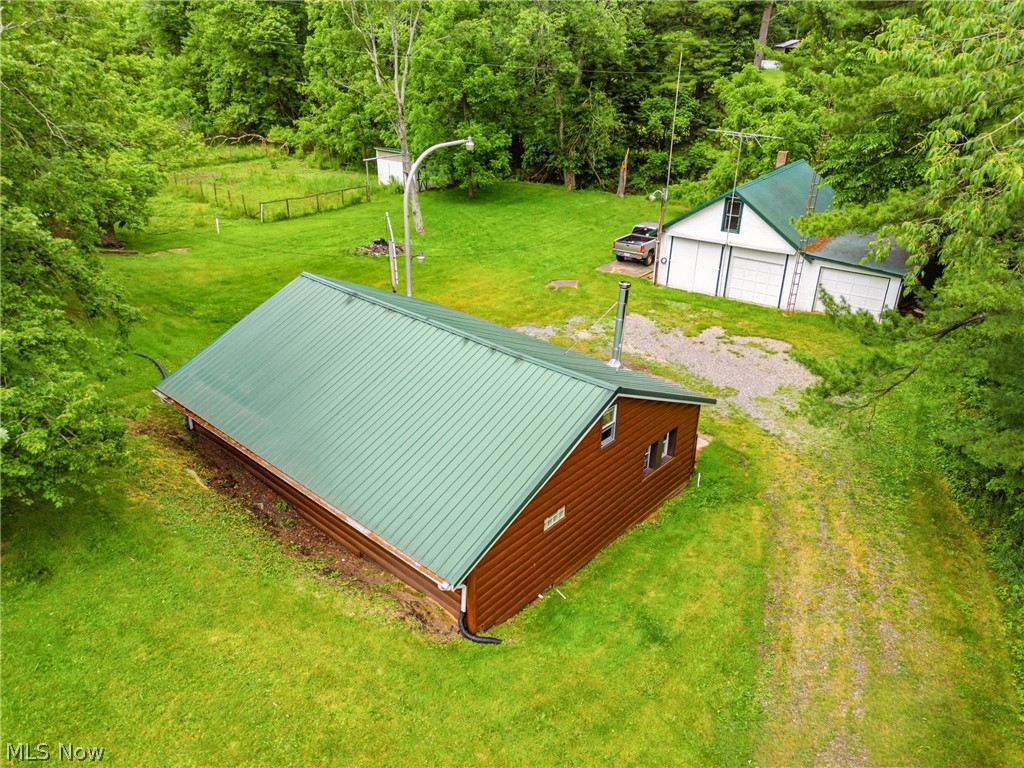 Here's your chance for a property with loads of potential in Canton South! Whether you're looking for a multi building homestead or an investment opportunity for multiple dwellings, this property acts as a blank canvas in an amazing location. Situated in East Sparta the property falls into Canton South's Pike Township just down the road from Spring Valley Golf Course. The main home built into the side of the hill offers roughly 1200sf of open concept living area that features main floor laundry, a master bedroom with direct access to the patio and bathroom, and a loft area upstairs perfect for additional sleeping quarters. The vaulted ceilings in the kitchen and dinette area give a spacious feel and the stone wall adds loads of character that's sure to carry over to whatever updates the next owner is looking to make. New metal siding was installed roughly a year ago while the metal roofs on the main home and garage were put on roughly six years ago. A newer propane furnace heats the main home. Head outside to the gravel drive and you'll find a spacious three car garage and workshop area that will be perfect for multitudes of uses. A bathroom in the garage is a great feature as well as the dedicated single stall and two stall separation. Head upstairs and you'll fine a potential apartment that's ready for finishing. Also on the property is a storage building that once acted as the main home. The block basement area leads right up to the second floor that features a few rooms, all of which could be situated however the next owner needs. Last but not least is the small horse area, a barn offers a couple stalls while the main fenced in area just needs spruced up to be used again. Places like this don't come along often! Call today for your private tour!
