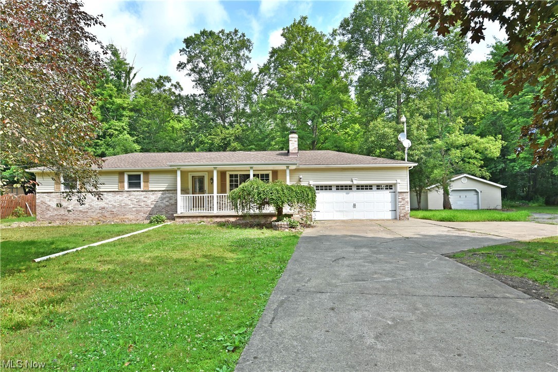 Masterfully remodeled and move-in-ready, this stunning Newton Falls residence won’t be around for long! Quickly delighting with its desirable open central layout, the engaging design will have you quickly falling in love. The three-bedroom ranch sits at the end of a concrete drive as a second, oversized detached garage makes for easy vehicle or equipment storage alike. A prominent, covered front patio leads past elegant brick work as you step inside. The immediate family room finds a brick fireplace alight in the midday sun from the picture window. A second serving window peers into the kitchen, bringing the natural light into your cook space. Daring, dark stained cabinets accent the bright stainless appliances and sweeping granite countertops as recessed lighting shines from above. The substantial dining area oversees the rear great room, showcasing a second fireplace, tall ceilings and arch topped windows. Down a short hall, a striking full bath includes a lavish corner shower. Nearb