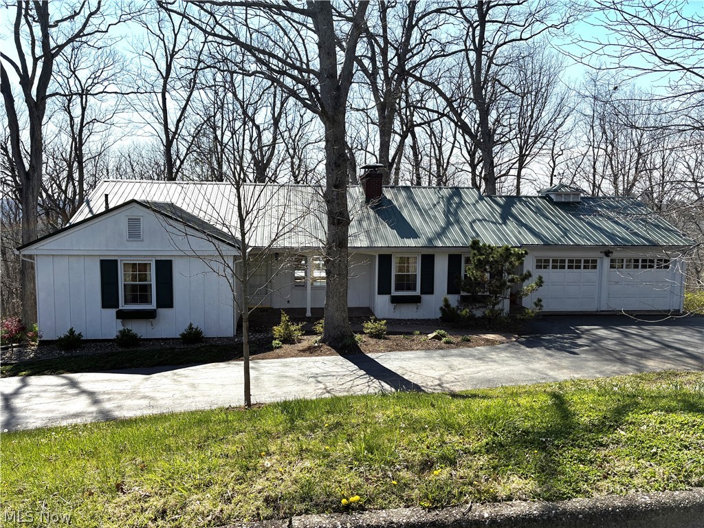 This cozy mid-century ranch style home offers you all of the charm of that era with its natural wood built-in book shelving, oak flooring, two fireplaces and a window wall that overlooks the state park like ambiance and privacy of the wooded home site that includes two platted lots. Use your imagination to situate the main  living space to accommodate your dining room and family room furniture to take advantage of the view and the fireplace that is equipped with gas logs. There are three bedrooms and one of them is equipped with the second fireplace with gas logs, a full bathroom and a private exterior entrance. There are laundry facilities in the attached two car garage that is accessed from the kitchen. All of this is located in walking distance from downtown Marietta and the Frontier Shopping Center. Call for your private showing soon as this one won't last long.