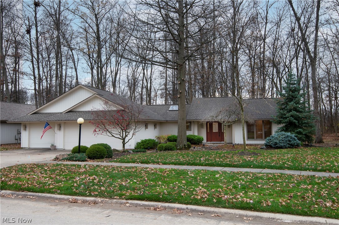 Spacious and custom best describe this luxury three bedroom home built in the second phase of the Bob Schmidt Ridgefield Development.  This high end, luxury ranch is move in ready right now! Nearly 3800 square feet of living space surrounds a large patio courtyard on three sides and looks out to a private wooded backyard.   The open floorplan living room/dining room area is perfect for entertaining family and friends, with a propane burning fireplace, built-in wet bar and large windows that bring in an abundance of natural light.  A private den or library off the foyer with built-in shelves makes working from home a treat.  The eat-in kitchen features a large walk-in pantry, an island with breakfast bar, expansive Quartz countertops, double ovens, skylight and a full wall of windows with sliding glass doors opening to a courtyard patio. The private owner's suite includes a separate lounge/sitting room, large bedroom and a huge walk-in closet with custom shelving that is a must see! Wha