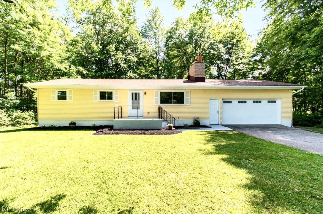 Peaceful is the best way to describe this location. Don't miss out on this beautiful turnkey Ranch. 4 bedroom, 2 full baths, large 2 plus car garage with opener located on a QUIET wooded lot. New windows, AC, electrical, all switches, carpet and luxury vinyl flooring throughout, lighting, electric fireplace, freshly coat of paint, front porch ,back deck, interior doors, microwave and dishwasher. Main floor bathroom has been completely remodeled. Don't let this one get away!