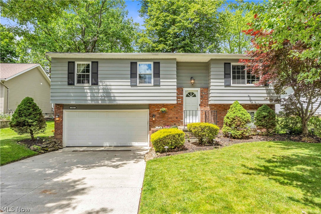 Welcome to 342 Brad Drive, a three bedroom, one and a half bath split-level home offering multiple living spaces, an attached two-car garage and a distinctive backyard in an established Brunswick neighborhood. The brick-and-aluminum exterior is complemented by mature landscaping and a welcoming entry with parquet flooring. Upstairs, the living room features a large front window and an open connection to the dining area, creating an easy flow for everyday living and entertaining. A sliding glass door off the dining room leads directly to the multi-tiered rear deck, with built-in seating and room for grilling, dining or relaxing outdoors. The kitchen includes tile flooring, white cabinetry, laminate countertops and a dual-basin stainless steel sink, providing a functional layout with opportunities for personalization. All three bedrooms and the full bathroom are located on the same level. One bedroom also offers direct access to the full bath, while the additional rooms provide flexibility for sleeping space, a nursery or a home office. The finished lower level adds valuable square footage with a spacious recreation room featuring wood-tone flooring, a gas fireplace with a character filled mantel and an adjoining half bathroom. This versatile area is ideal for a second living room, media space, game room or office. The lower level also provides direct access to the attached garage and the dedicated laundry and mechanical room. Outside, the backyard offers a layout rarely found in a typical suburban setting. The lower section creates a private gathering area, while the landscaped hillside features mature gardens and an established tree. At the top of the yard is a wide, level section with space for recreation, a play area, gardening or additional outdoor seating. A partially fenced upper yard adds even more functionality. With flexible interior spaces, a memorable outdoor setting and a convenient Brunswick location, this home is ready for its next chapter.