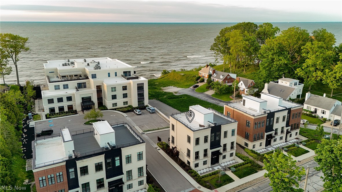 Nestled along the shores of Lake Erie in the exclusive 700 Lake community, this never-occupied luxury townhome delivers an exceptional blend of sophisticated design, effortless living, and breathtaking waterfront views. Offering over 2,100 square feet of thoughtfully curated living space, this residence was designed for those seeking a refined, low-maintenance lifestyle without compromise.

Walls of glass and expansive windows fill the home with natural light while framing stunning lake views from nearly every level. The heart of the home is the dramatic open-concept second floor, where 10-foot ceilings, a striking marble fireplace, and seamless indoor-outdoor flow create an atmosphere equally suited for intimate evenings or elegant entertaining.

The chef’s kitchen is a true centerpiece, featuring sleek quartz countertops, an oversized island, and a premium suite of Wolf and Bosch appliances, including a Wolf steam and convection oven. Every detail reflects modern luxury and timeless sophistication.

The upper level offers two private bedroom suites, including a serene primary retreat complete with a spa-inspired bath and spacious walk-in closet. A first-floor guest suite or private office provides flexibility for today’s lifestyle needs, while the conveniently located upper-level laundry enhances everyday ease.

Crowning the residence is an expansive rooftop terrace with panoramic Lake Erie views — a private sanctuary perfect for sunset gatherings, morning coffee, or quiet evenings overlooking the water.

Located just minutes from Rocky River’s premier dining, shopping, parks, and waterfront amenities, and only 15 minutes from downtown Cleveland, this exceptional home offers the rare opportunity to enjoy lock-and-leave luxury living in one of Northeast Ohio’s most desirable lakefront communities.

Why wait for new construction when this extraordinary residence is move-in ready today?