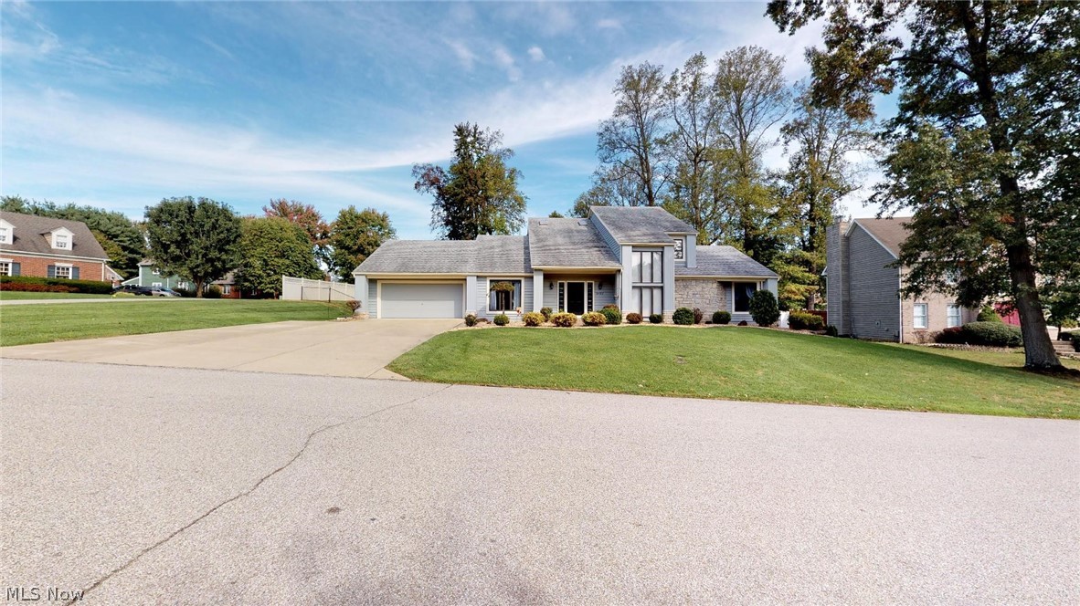 Wonderful contemporary style home with open floor plan, vaulted ceilings and 2 story stone fireplace. Inviting Cherry kitchen with ample lighting and an abundance of storage and Cherry hardwood flooring, 1st floor master with covered deck perfect for relaxing! Fabulous back deck! This home has been freshly painted throughout and the sellers have purchased new carpeting that will be installed soon to replace all of the carpeting.