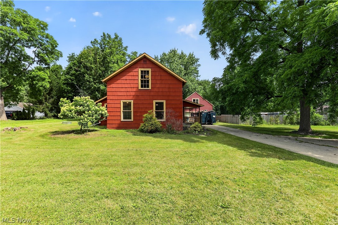 Two-story colonial-style farmhouse originally constructed in 1863, situated on a 1.62-acre level lot in Olmsted Township. This property features 2,048 square feet of interior living space, configured with 4 bedrooms and 2 full bathrooms. The first-floor layout includes a dedicated den space, which provides optionality for a primary bedroom configuration or office space, alongside main living areas and an updated kitchen. The upper level includes three additional bedrooms and an open loft area. Structural amenities feature central air conditioning, forced-air heating, and a partially finished basement footprint. The exterior configuration includes a substantial detached two-car garage equipped with a 20x20 overhead loft space and an independent gas furnace heating system. The acreage features an expansive rear yard setup with a paved patio area.
