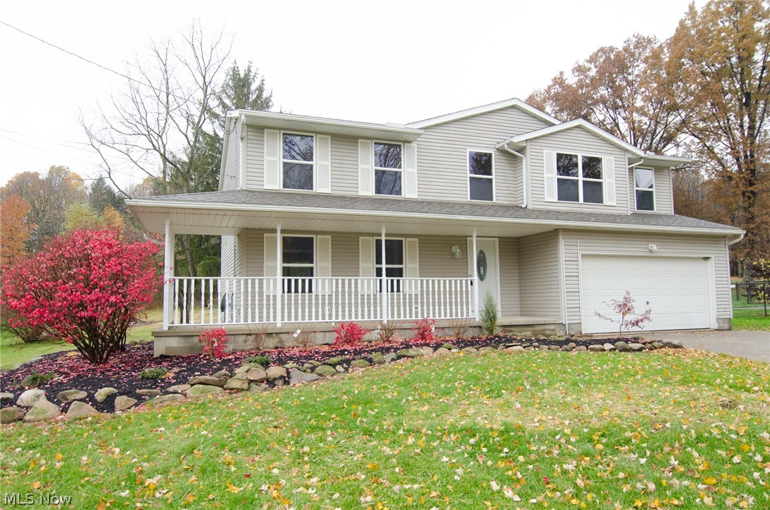 Four bedroom home in Tallmadge!  Tucked back from the road on over an acre, with lots of privacy.  The spacious floorplan begins with nice hardwood foyer & opens up to what could be used as a formal dining room, sitting room or play space for the kids.  There is a bright living room that opens to the dining area & kitchen.  This open space is perfect for entertaining & has sliders off the eating area, out to the large deck.  The kitchen features new lighting, sink, faucet, stainless microwave, dishwasher, range, refrigerator & locking vinyl flooring.  Off the kitchen is the main floor laundry room, with a large closet & access to the garage.  There is also a half bath & coat closet on the first floor.  Upstairs you can over look the bright 2 story entry & contemporary light fixture, from the second level. You will be ready to sign the offer, when you walk into the massive master bedroom!  The master bath is wonderful as well, with new tile flooring, new tub & tile surround, new toilet