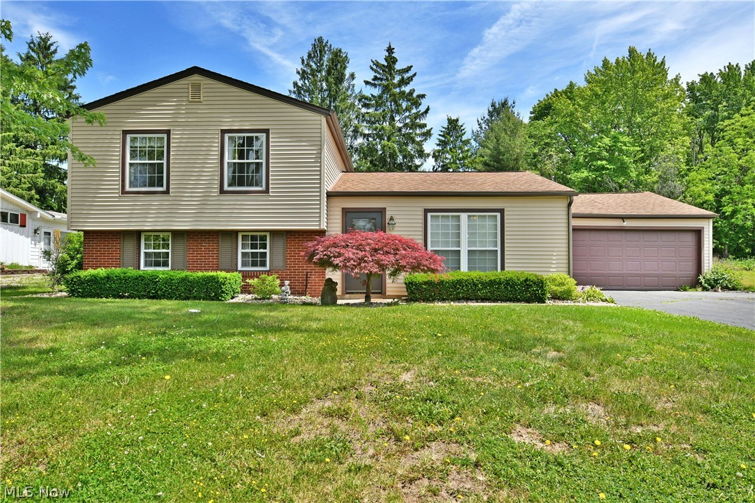 Your next adventure just arrived, and YOU get to finish the story however you choose! Welcome home to three floors of comfortably casual, move-in-ready living space right in the heart of Howland. The darling split level checks all the right boxes; location, price, and cleanliness with its easily lived surroundings that are ready for you to enjoy as is, or as a canvas to your creativity. Boasting plenty of curb appeal, its colorful landscaping and perfect mix of both warm and natural colors; accented by brick, create an instant standout. A two-car attached garage adds to the appeal, while around the back, a must-see rear sunroom overlooks the lush yard and a large storage shed for additional storage needs. Inside, the gracious living room takes full advantage of its tall picture windows as the tiled foyer transitions to plush carpets. Hardwood styled offerings run underfoot in the ample dining space that joins the high contrast kitchen with its dark stained cabinetry. Upstairs, a trio of impressively sized bedrooms are joined by a deep-set full bath that’s tied into the larger master for private access. Down below, the wood panel lined family room offsets both an additional half bath, laundry and storage areas.