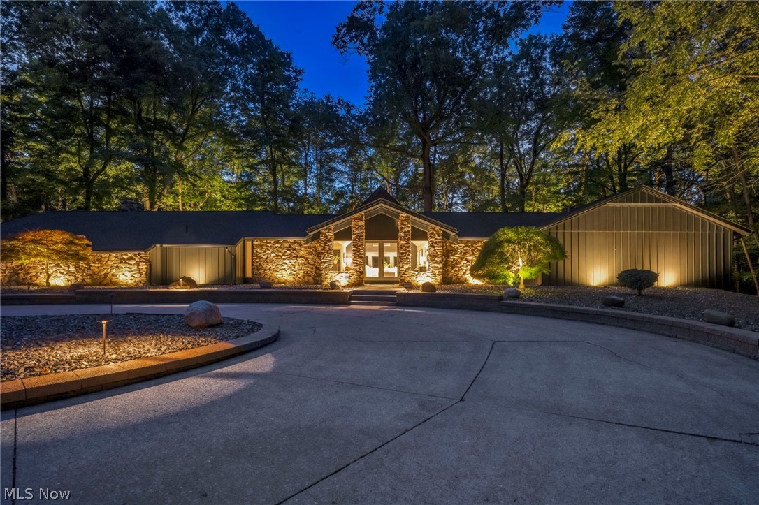 Welcome to one of the most extraordinary residences ever offered in Strongsville's prestigious Ledgewood Development.
Positioned on the largest, most private homesite in the entire community, this fully reimagined 4,200-square-foot sprawling ranch is a rare offering that simply cannot be duplicated. Surrounded by mature trees and overlooking the breathtaking Metroparks, this estate delivers a level of privacy, tranquility, and exclusivity seldom found in Northeast Ohio.
Originally built by Iconic Ledgewood developer Bob Schmitt and completely transformed to today's luxury standards, every inch of this residence has been meticulously redesigned with an uncompromising commitment to quality, craftsmanship, and sophistication. The result is a seamless blend of timeless architecture and modern luxury that rivals custom-built homes costing substantially more. From the moment you arrive, it becomes clear that this is not merely a home—it is a private retreat. Expansive living spaces, refined finishes, and thoughtfully curated design elements create an atmosphere that is both elegant and welcoming. Walls of windows frame spectacular views of the surrounding landscape, bringing the beauty of nature indoors while flooding the home with natural light. The outdoor experience is equally remarkable. The estate-sized 1.5-acre setting offers complete privacy, professional landscaping, extensive landscape lighting, and panoramic Metroparks views that change beautifully with each season. Whether entertaining guests or enjoying a quiet evening under the stars, the setting is nothing short of exceptional. Within a development of more than 300 homes, opportunities like this are virtually nonexistent. A property of this caliber, on a homesite of this magnitude and location, may only become available once in a generation. For the discerning buyer seeking privacy, prestige, single-floor luxury living, and a truly irreplaceable setting, this is the opportunity of a lifetime.