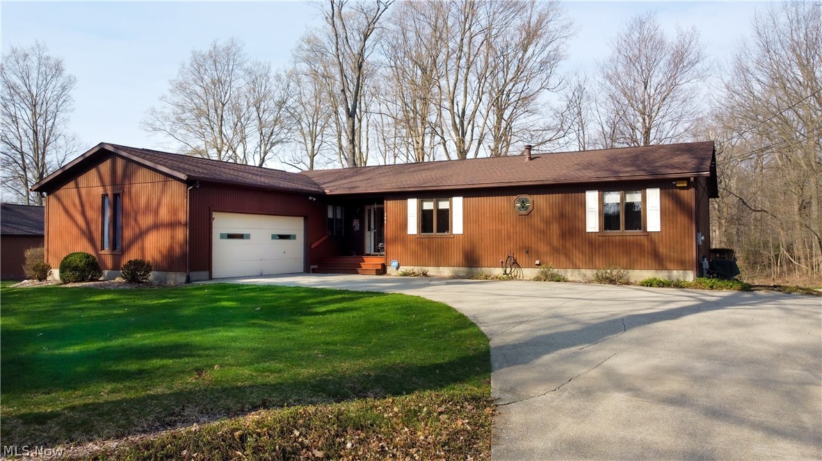 Ranch living on nearly an acre! Meticulously maintained 3 bedroom with 2 full baths, all on the 1st floor. Spacious eat-in kitchen includes ALL appliances (stove, fridge, microwave, dishwasher), plus basement laundry includes washer/dryer. Dining room off the kitchen features sliders to a large screened porch . Living room includes a fireplace. Even more living area in the basement with a finished rec room. But the truly spectacular feature of this home is the 30'x40' outbuilding, complete with 2 enormous overhead doors, heater, hot/cold water, and air compressors, could easily fit trucks, toys, 4 or more cars, etc. Other features: nearly 1 acre, serene setting, attached 2-car garage, multi-level deck, conveniently located near freeways and just minutes to Akron or Cleveland.