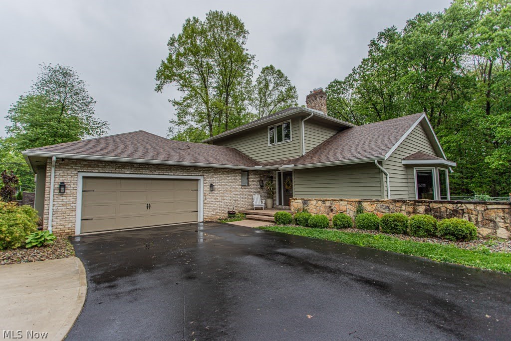 Welcome to this immaculate, turn-key residence offering the perfect blend of modern upgrades and an unbeatable location which is  close to everything but still feels private! Nestled on a lush 0.53-acre lot in Boardman Township and within the Canfield Local School District, this beautiful 3-bedroom, 3-bathroom conventional home enjoys a rare, highly private setting directly adjacent to Mill Creek Park.

Step inside to a bright, open interior featuring sleek vinyl plank flooring, a fresh coat of paint, and newly updated lighting and electrical fixtures throughout the home's spacious 2,928 square feet of living space. The custom kitchen is a chef’s delight, showcasing elegant granite countertops, premium cabinetry, and a full set of stainless steel appliances updated in 2022. All three bathrooms are full baths, highlighted by a luxurious master bathroom fully remodeled in 2023, complete with an adjacent custom closet organization system installed in 2021.

The partially finished lower level provides a versatile spare room with gas fireplace. A new sump pump with a battery backup system was also added in 2026. A BRAND NEW air conditioner is scheduled to be installed on June 1. Major capital improvements have already been meticulously completed for you, including a new roof, gutters, downspouts, and exterior paint (all in 2021), as well as high-end, energy efficient Pella Impervia windows (2021). The exterior also features fully updated drainage with French drains (2020) and a brand-new driveway (2022).

The outdoor space is a true garden-like oasis. Extensive professional landscaping with beautiful stone accents surrounds the property, while the ultimate outdoor entertaining setup awaits on the 20x20 stamped concrete patio. Want some fresh eggs? Raise your own flock of hens in the chicken coop!

This meticulously maintained property offers an unmatched combination of modern comfort, structural longevity, and park-side living. Schedule your private tour today!