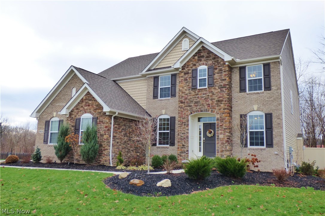 This 2,900 sq. ft. 4 BR, 2.5 BA brick & stone front Colonial is just 2 years young and shows like a model home!  The highly desired open floor plan with huge eat-in Kitchen is open to the 2-story Great Room with a wall of windows and the awesome fireplace.  The home is loaded with upgrades including hardwood floors, floor-to-ceiling stone faced gas fireplace and a finished lower level just to name a few. The Kitchen features an abundance of cabinets, center island, planning center, large Pantry, granite, hardwood and stainless appliances. A Butler's Pantry area leads to the Formal Dining Room. To the right of the Foyer is a private Office.  4 Bedrooms on the 2nd floor including the huge Master Suite with Glamour Bath w/ tile floor, dual vanities, corner soaking tub, tiled shower and and expansive walk-in Closet. Your will love the convenience of the 2nd floor Laundry Room with high efficient washer & dryer. The finished Lower Level Rec Rm provides extra space for entertaining, work-out
