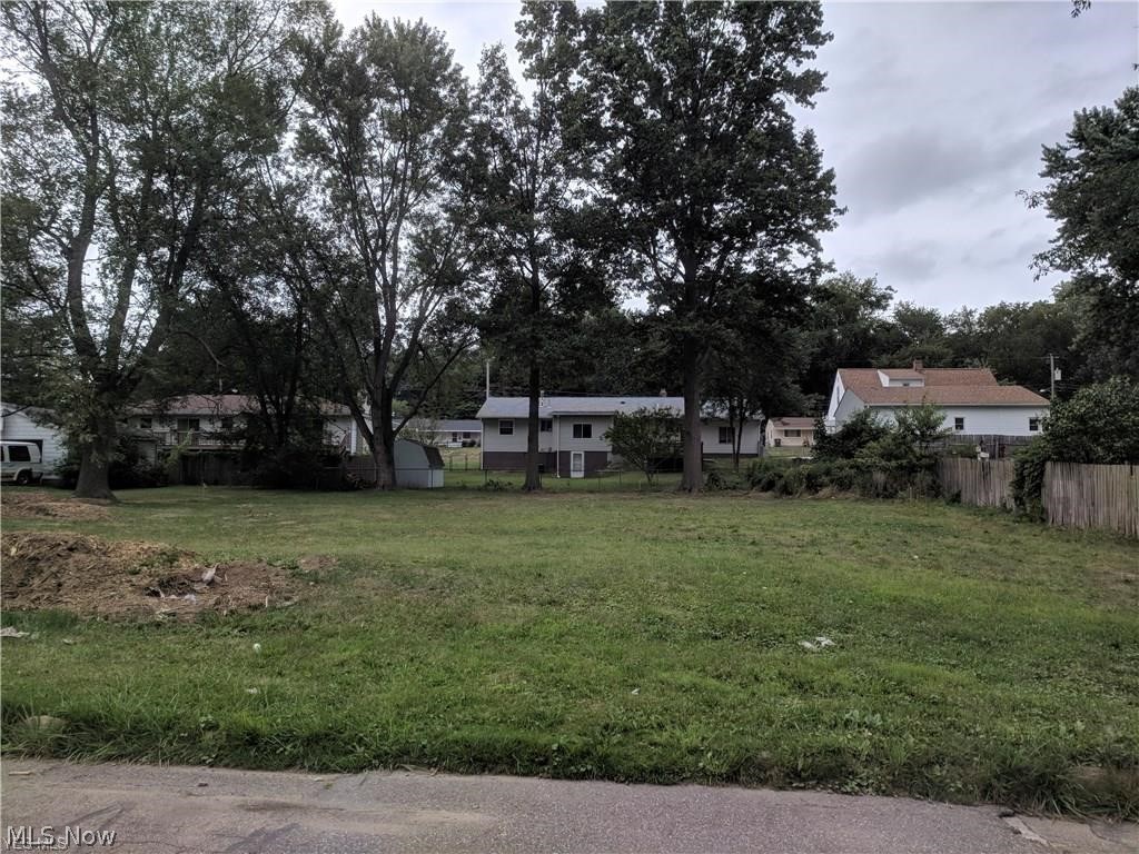 Nice buildable residential lot Priced well and ready to build, zoned single family that has 90 foot frontage and is 118 ft in depth. All utilities are at the street. As the story goes a very small  house was located on the far right corner of the lot that burnt down, after the fire, derbies was professionally removed and typically they remove the top few feet of the block foundation, punch out the flooring and then back filled.  According to Chip at Akron building department this lot is acceptable to build on. Good value buy here.