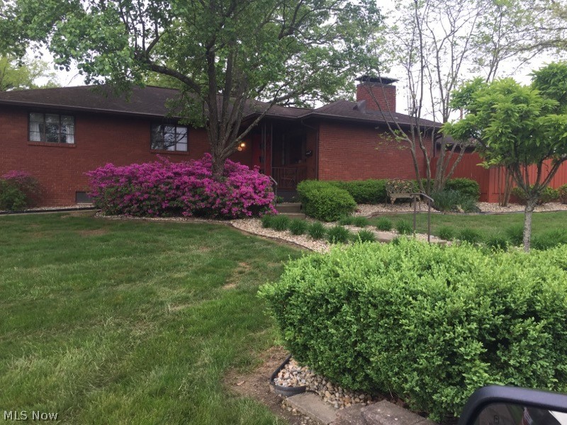 Exquisite, move-in ready Brick Ranch home!  3 BR / 3 BA.  Open Concept!  Environmentally minded cork flooring throughout the kitchen, dining room and hallway!  Granite countertops, top of the line cabinetry, hand crafted center island countertop and matching built-in!  Master Bedroom and adjacent bedroom both also have wonderful built-ins.  Updates have been done with respect to the mid-century modern style!  Full basement with finished recreation area and family room - massive laundry room with extra storage and workshop or gym as you see fit!  Enjoy the hassle free landscaping and fabulous deck for parties and BBQ!