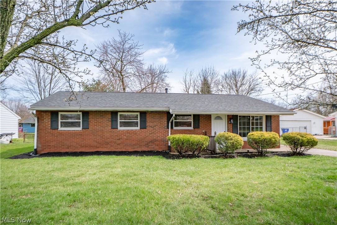 Fresh updates and easy one-floor living come together in this beautifully refreshed brick ranch in Kent! Set on a .22-acre lot in Brimfield Township, this 3-bedroom, 1.5-bath home offers a bright open layout connecting the living room, dining area, and updated kitchen for comfortable everyday living. The kitchen features a center island with breakfast bar seating, stainless steel appliances, tile backsplash, and plenty of workspace, while the large enclosed 3-season sunroom adds even more room to relax, entertain, or enjoy views of the backyard. All 3 bedrooms are conveniently located on the main level and share a fully renovated full bath, while the updated half bath includes space for a stackable washer and dryer. Recent improvements include new flooring, lighting, fixtures, baseboards, recessed lights, interior and exterior doors, a new roof on the main house, French drains around the property and beautifully updated kitchen and bath spaces! A detached 2-car garage, covered front porch, public water, and public sewer complete the package. A move-in ready opportunity close to Kent amenities, shopping, dining, and commuter routes!