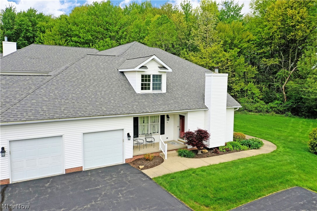 Meticulously curated with casual country feel, this gorgeous two-story Howland homestead is just the condo-style living that you’ve been looking for! Located just moments away from the area’s most desirable golf courses and attractions alike, this residence puts you in the heart of the action. Explore this darling corner unit that includes secure garage parking and secondary hallway entry. Meanwhile, a covered patio space joins the formal entrance, perfect for warm weather relaxation. Inside, the warm colors pair with natural colored carpet flooring as you take in the stunning views and welcoming sunlight from the towering, arch topped windows. A wood trimmed fireplace is found along the near wall as central dining takes full advantage of the sun. Towering ceilings extend over the open layout as the stairway climbs to find a gracious loft overlook. Past central dining, an immersive kitchen includes its own casual corner for daily meals, offsetting the dark stained cabinetry. Around the corner, a closet lined hall finds a half bath before opening to the first-floor master bedroom suite. Revel in the full private bath and bonus walk-in closet that completes the floor. Upstairs, a second full bath offsets the loft while an oversized guest bedroom enjoys its illustrious nook, a perfect office space or lounge. Downstairs, a full basement yields plenty of storage and laundry services. Laundry may also be located in the designated closet on the first floor.