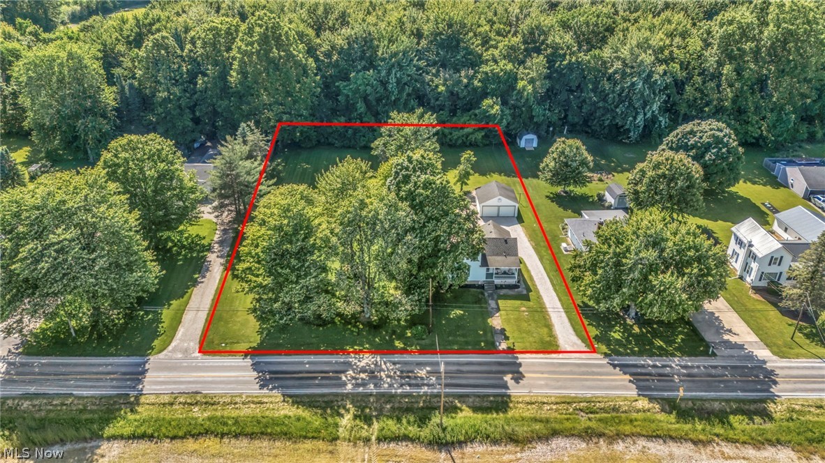 Calling all country lovers! Don't miss this beautifully updated/remodeled Cape Cod-style farmhouse situated on a quiet 1-acre lot in desirable New Russia Township. Major updates were completed in 2021, creating the perfect blend of original character & modern conveniences, all at an affordable price. Manageable yet spacious lot offers plenty of room for entertaining, gardening, pets or simply relaxing while enjoying the peaceful country setting. A 2-car garage has been upgraded with new doors & additional electrical service. Septic system was recently inspected and found to be in good working order, providing added peace of mind. This charming & inviting home welcomes you with a relaxing front porch, perfect for morning coffee or an evening book. Inside, you'll find a beautifully updated kitchen sure to impress any cook, complete with appliances included. Spacious formal dining room features attractive wood flooring & provides the perfect setting for family gatherings and holiday meals. Comfortable great room combines modern updates with timeless character, highlighted by exposed original brick chimney accents & beautiful hardwood flooring. A first-floor bedroom & updated full bath featuring premium fixtures and a walk-in shower provide convenient main-floor living. Additional improvements include added city water service for everyday convenience while retaining the original well for outdoor use, upgraded 100-amp electrical service, low-maintenance vinyl siding plus new HVAC system with central air installed in 2021 for year-round comfort and efficiency. Truly a fantastic opportunity and a rare find offering country living, modern updates and classic farmhouse charm.