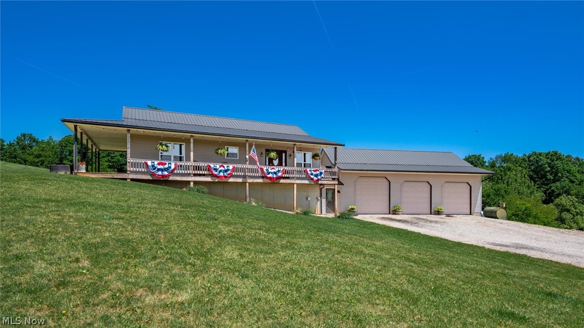 WOW! Sitting at the top of 6.54 gorgeous acres with the most breath-taking views, this is it! As you pull up to the beautifully situated property, the first thing you'll notice is privacy, peace, and quiet. Built in 2010, this raised ranch is bursting with customization, and amazing potential for expanded living space. Entering from the ground-level, turn right and you'll walk into a HUGE 30'X40' 3-bay garage with heated floors and its own a/c unit, two 9'X9' doors and one 10'X10' door (perfect for larger vehicles or machinery). To the left you'll walk into a complete basement space that also has heated floors, already framed and professionally wired, ready for your finishing touches (recreation room/bedrooms/office space/etc). And, so much storage space! The spacious lower level also includes a finished full bathroom, conveniently located for easy access from outside for those messy cleanups! You'll also find a newly constructed overhang and back patio for quiet moments while enjoying the backyard, an additional 16'X40' lean-to for extra vehicle/equipment storage, and a 20'X42' wood barn! Walk up to the main living level where hardwood floors and beautiful freshly installed carpet create warmth, and enjoy the light-filled living space highlighting the land and stellar views. Custom hickory cabinets and spacious kitchen, ample counter space and a gas range make light work of meal prep. The large owner's suite boasts its own walk-in closet, ensuite bath with a walk-in shower and double vanity, and direct access to the wrap-around porch. Yes, wrap-around porch, where you'll have a front seat to starry nights and a view for miles! Welcome to your own slice of paradise!