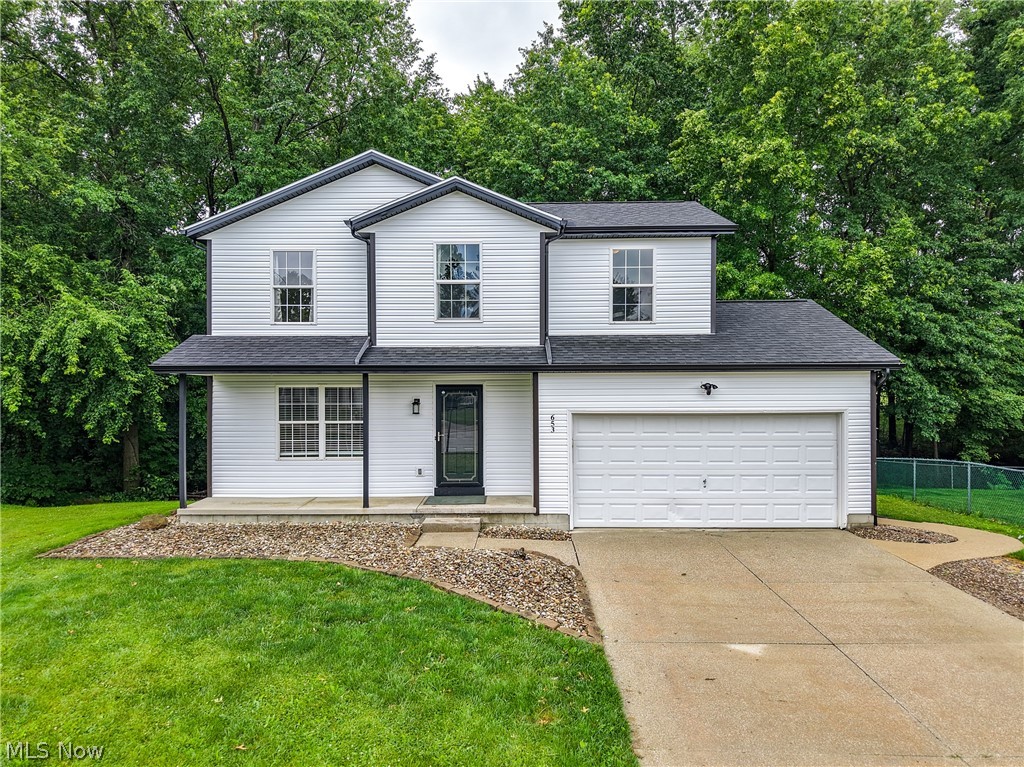Tucked back on a cul de sac in the quaint Diamond acres neighborhood, is just what you have been waiting for!  A gorgeous 4 bedroom, 3 bathroom home with tons of great updates!  The crisp, modern exterior features brand new siding, soffits, gutters and contrasting black trim!  Easy maintenance rock landscaping wraps the front of the house and creates a walkway to the back patio.  Brand new steps and deck railing with a rustic burnt wood finish and solar lights!  This ultra private back yard area is truly a dream, with a thick forest of mature trees and a charming creek.  Kids and nature lovers won't be able to get enough!  A small bridge crosses the creek to a cleared area that is perfect for a play spot, to build a fort or just sit and enjoy all the wildlife.  The covered front porch is just the right space for a couple of chairs and to display holiday decorations too!  Just inside is a foyer area, coat closet and refreshed half bath.  To the left is the formal living room, filled with wonderful natural light.  The luxury vinyl plank flooring (just installed in 2023) takes you into the open dining & kitchen areas.  Slider to the deck new in 2025.  Kitchen comes equip with all appliances (dishwasher new 2025) and that incredible view of the woods!  Don't miss the pantry and garage access!  New carpet takes you upstairs, where  you will find the primary suite with a private bathroom, 3 additional bedrooms, 2 linen closets and a second full bath!  The basement provides excellent storage, laundry and room to finish off as a rec or game room.  Not too be missed is the new A/C in 2024, roof 2022, furnace and water heater in 2021  Just 4 minutes to the center of downtown Ravenna, 9 minutes to West Branch, 10 to golfing at Windmill Lakes and 11 minutes to Kent State University!  CALL NOW for your chance to tour this beautiful home in person!