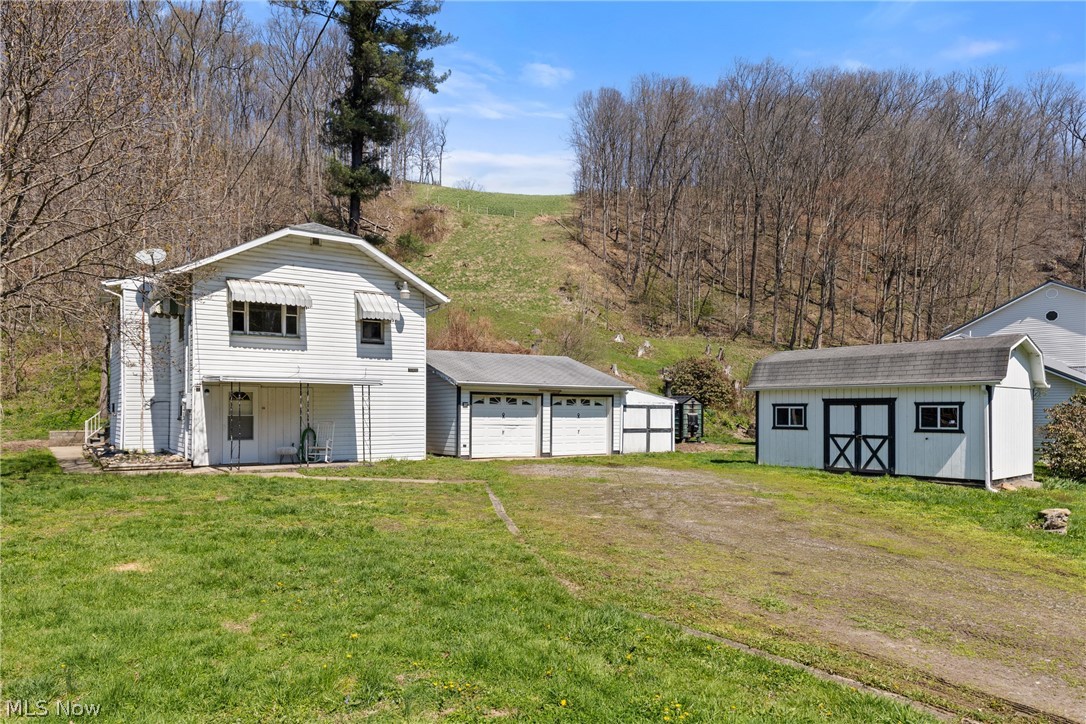 Welcome to your own little slice of country comfort at 329 Township Rd 117 in Mingo Junction! Nestled on nearly an acre, this charming property offers the perfect blend of fresh updates, functional space, and endless possibilities. Step inside to find a warm and inviting 2-bedroom home that’s been thoughtfully refreshed with new doors, fixtures, fresh paint, and all-new flooring throughout the main level, giving the entire space a bright, clean, move-In-ready feel. Both bathrooms have been beautifully remodeled and updated, adding modern style and convenience where it matters most. Outside, the value keeps unfolding. The detached 2-car garage provides plenty of room for vehicles, hobbies, or workshop space, while the attached lean-to offers even more storage for tools, outdoor equipment, or seasonal items. Need extra room for projects, a studio, or your dream workshop? The additional shed with electric and windows is a rare bonus space ready to become whatever you imagine. Whether you’re looking for peaceful outdoor space, room to spread out, or a home that’s already been refreshed for easy living, this property checks all the boxes. Opportunities like this don’t come along often. Schedule your private showing today and come see all the potential waiting for you! New roof 2022-AC 2028-Contact agent for full list of updates. **MINERAL RIGHTS DO NOT CONVEY**