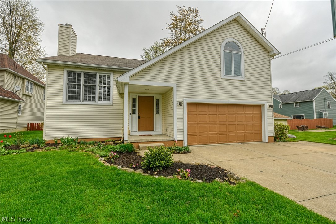 Amazing space in Mogadore!  You will have all the room you need, in this 4 bedroom home.  Located on a cul-de-sac, with an extra wide driveway and 2 car garage.  Enter into the ceramic tiled foyer, where you can also access the garage.  Up to the stunning living room with vaulted ceilings and wood burning fireplace.  The open floor plan guides you right into the dining and kitchen areas.  Beautiful wood floors, vaulted ceiling with sky light and sliders to the deck.  The kitchen offers solid oak cabinets, a center island, new range, new dishwasher and refrigerator included.  While still on the main floor are the master bedroom, with access to the full bath, 2 hall closets and another bedroom.  The most interesting part of the home is up from the living room on the 3rd level.  This massive room has a vaulted ceiling, ceiling fan, large windows and a bonus room!  This special loft area can be accessed by adding a ladder or steps.  Perfect location for an office or secret playroom.  Down