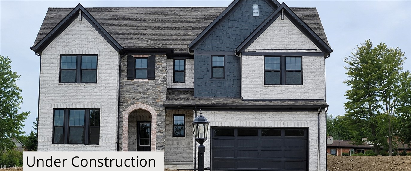 Introducing the award-winning Hollister plan, thoughtfully designed w/ the primary bedroom on the main level & enhanced throughout w/ high-end finishes. Positioned on a spacious corner lot, this new-construction home offers modern elegance, comfortable living, & exceptional craftsmanship. The stunning exterior features a timeless blend of light brick, stone accents, & James Hardie siding.  Architectural gables, dark trim, & a covered front entry elevate the curb appeal, while the carriage-style garage door & upgraded exterior lighting complete the upscale look. Bright main level w/ 9’ ceilings, wide-plank hard-surface flooring, & an inviting electric linear fireplace w/ full-height stone surround. The gourmet kitchen features Cashmere Taj quartz countertops, Aristokraft Benton Birch cabinetry, a premium Whirlpool gas appliance suite, a custom wood hood, a large island w/ upgraded detailing, & a striking vertical subway tile backsplash. The main level also includes a dedicated home office, welcoming foyer, laundry, & an upgraded sliding glass door that seamlessly connects to the outdoor living space. The first-floor primary suite offers a peaceful retreat w/ soft carpeting & a spa-inspired bath showcasing Carrara Breve quartz, a frameless matte-black shower enclosure, Calacatta Sky tile, & dual sinks w/ matte black Moen fixtures. Upstairs is a spacious game room / loft area complemented by secondary bedrooms & baths featuring quartz counters, upgraded plumbing fixtures, & thoughtfully selected hardware and finishes. The partially finished basement offers a spacious rec room & a convenient half bath—ideal for entertainment, guests, fitness, or hobbies. Additional functional features include a tankless water heater, sump pump with battery backup, Z-Wave smart thermostat & 200-amp electrical service. This Hollister home blends thoughtful architecture, premium finishes, & comfortable everyday living. Estimated Completion, July 2026.