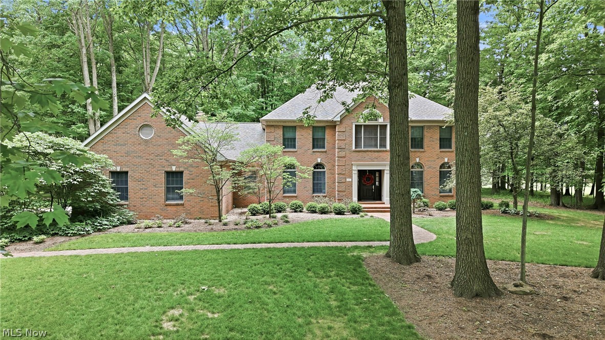 Spectacular 2-story home custom designed for original owners in 1994 by David Stevenson. Handcrafted mahogany door leads to front hall with marble flooring, closets and cherry staircase. Cherry flooring, doors, crown molding, window trim & doorways, built-in shelves & cabinets plus desk in den, and 2 vanities. Baldwin brass door knobs accent all doors. 1st floor of home has 9-foot ceilings. Upstairs ceilings are 8-feet high. Upstairs bathrooms and laundry room have Summitville Tile floors. Countertops are Fountainhead solid surface in 1st & 2nd floor bathrooms and kitchen. Anderson Windows view the 1.52 acre wooded-lot. Front of home features arched-top windows on 1st-floor and large central palladium window on 2nd floor. Black-out shades and wooden blinds are extra features. Home was built to be functional. Two walk-in closets in master suite, and two other bedrooms also have walk-in closets. Finished "bonus room" off upstairs front bedroom closet can be used for variety of purposes. Attic is accessible off of bonus room and provides additional storage opportunities. Basement was finished several years after home was built and features drywalled walls, carpeting, overhead fluorescent lighting, full bath, and plenty of storage. Bilco door provides egress to outside from basement. 3-car garage and screened-in side porch off concrete driveway. Recent updates include: carpeting, fresh paint, ceiling fans in 2 bedrooms, black-out shade across front of home, and LED closet lighting. Kitchen upgrades include: Bosch dishwasher (2025), GE stove (2019), GE refrigerator (2019), new faucets, backsplash, cabinet hardware, beverage center refrigerator (2025), and new small sink. Laundry room has new utility sink and new Speed Queen washing machine. Home is heated and cooled with geothermal water furnace unit. New compressor (2006), circuit board (2006), and blow motor (2008) were added.