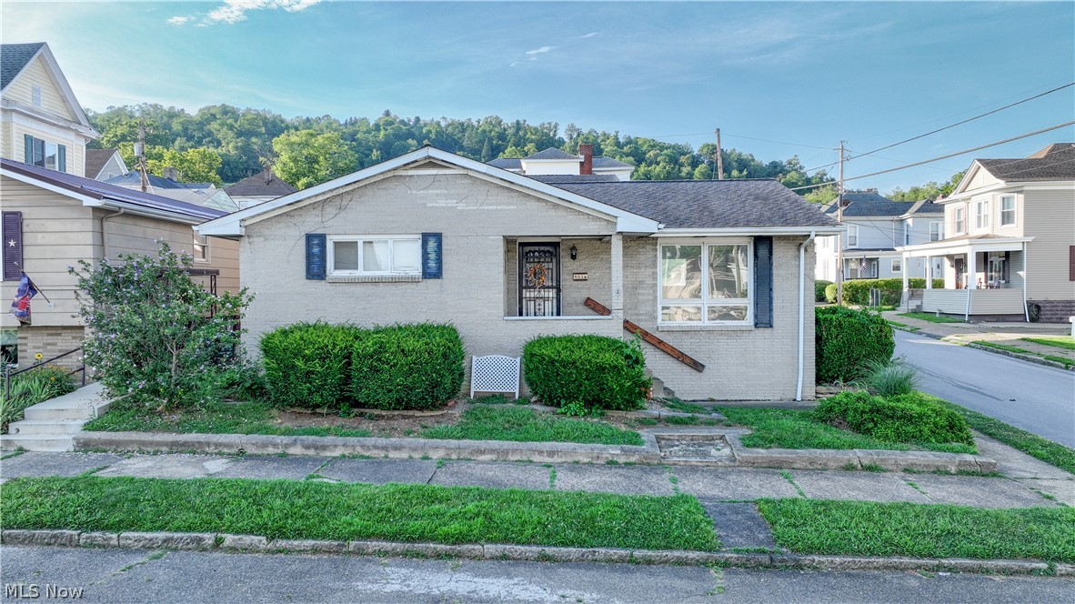 Home with bonus apartment and potential income! Located on a corner lot in Martins Ferry, Ohio, this ranch home offers a comfortable layout, generous living space, and the added bonus of a separate apartment above the detached garage. The main level of the home features a functional kitchen, living room, three bedrooms, and a full bathroom, providing a layout that works well for everyday living. The fully finished basement adds even more usable space with multiple recreation and gathering areas, along with an additional bathroom. Whether you need room to entertain, relax, or create a hobby or game room, you'll appreciate the flexibility this lower level provides. Outside, you'll find an extra-large covered back porch that's perfect for enjoying your morning coffee or spending time with family and friends. The detached two car garage offers parking or plenty of storage, and the garage's second-level apartment is 855 sq. ft. and includes two bedrooms, a full kitchen, a living room, and a full bathroom - making it a great option for guests, extended family, or potential rental income.