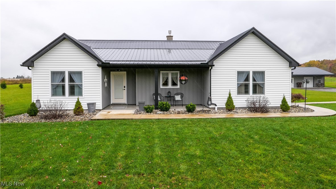 Take a look at this immaculate ranch home built in 2021 and sitting on over 16 acres. The spacious kitchen has beautiful quartz countertops, grey cabinetry with a black glaze, a conveniently placed island right in the middle, and a kitchen bar seating area. There's also a pantry off of the kitchen for extra storage. The dining area has big windows for good natural lighting and plenty of space to eat at a proper dinner table. The living room is spacious and has hardwood flooring throughout. The open concept with the fireplace in the middle keeps the home nice and warm during the winter. The massive master bath has a freestanding tub along with a shower, a double white and grey vanity, and has hardwood flooring throughout. The master bedroom in spacious with its own walk in closet. The foyer is big enough to turn into a 3rd bedroom if need be, and has a half bath with a chocolate and white vanity. The back porch and patio is beautiful and can be enclosed during the winter. The barn has plenty of space to park vehicles, store tools, turn into a work area, or have large indoor get togethers, and there's a full bathroom inside the barn. The garage is also big enough to store a vehicle, mowing equipment, and extra tools. The over 16 acre lot is perfect for anyone who wants a garden, farm, or just a large outdoor space for whatever their heart desires. Come and make this beautiful home yours today!