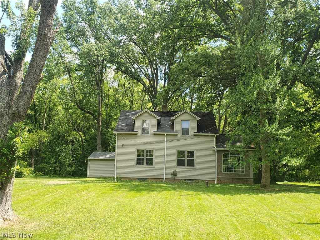 So much potential to make this a perfect little home!  Needs a little TLC to bring it to life, but just waiting for that handyman to come in and take it away! With a little cosmetic upgrading, you could have a great starter home on 5+ acres of land which is almost impossible to find! Home features 2 bedrooms, one bath, enclosed patio, and a full basement.  Detached 2 car garage, plus an additional outbuilding. Over 280' of road frontage makes this wide open lot a beauty! Being sold As-Is, (VA or FHA financing will not work on this one)