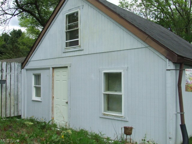 Bungalow with 3 bedrooms, living room, eat-in kitchen and large family room.  One bedroom is converted garage and shares closet in the hallway with another bedroom, you walk through this bedroom to get to the upstairs 3rd bedroom. Kitchen has oak cabinets, eating area, large counter, and open pantry at top of basement steps.  Family room in back with cathedral ceiling is currently used as office and is open to kitchen and out to large deck on side of house.  Home needs some work, value may be in the land - .76 acre.  Detached 1-car garage and 2 sheds.  Motivated seller, prefers to sell "as is".