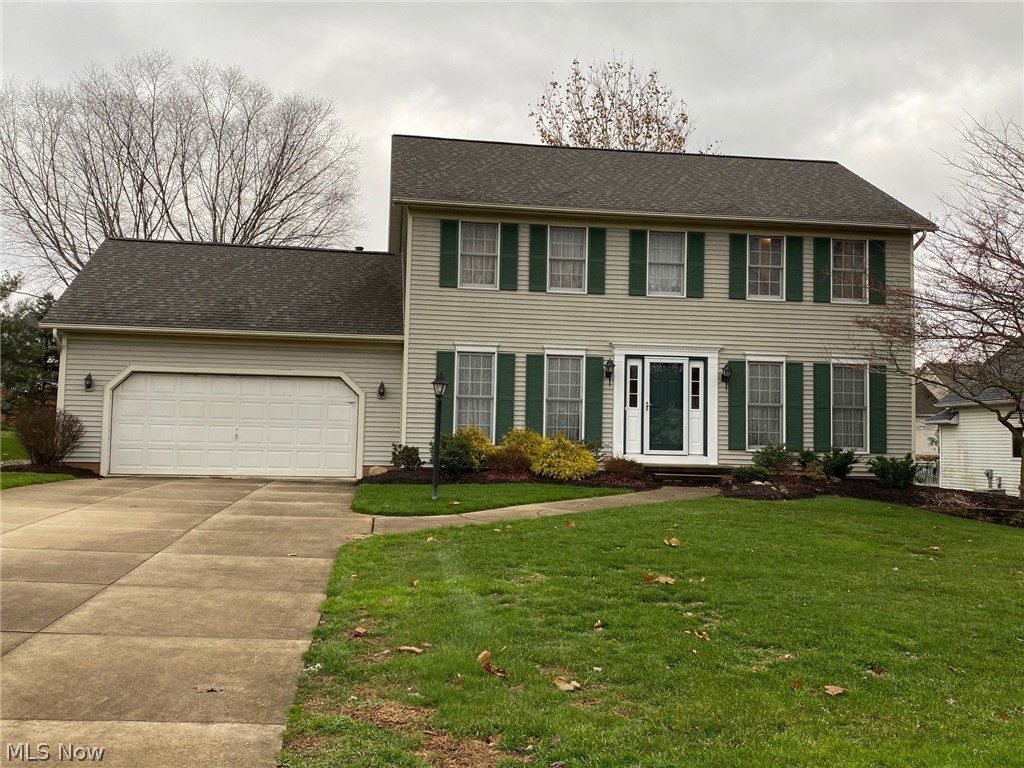 Beautifully kept 4-bedroom, 2-1/2 bath Colonial with open floor plan between gas-fireplaced family room and fully applianced eat-in, updated kitchen with sliders to deck.  Original owners have taken great care of this home on a cul-de-sac in Tallmadge Hills.  First floor also has formal living room, formal dining room, double coat closet, half bath, laundry room and entrance to attached, deep 2-car garage.  Upstairs are four nice-sized bedrooms, including master bedroom with master bathroom and walk-in closet, and main bathroom.  Lower level consists of two family rooms, one with wet bar type sink, and storage area with room for desk or work-out area.  Updates include roof-4 yrs, A/C-5 yrs, H2O-4 yrs, kitch-2 yrs, basement carpet, some painting.  Home warranty included.
