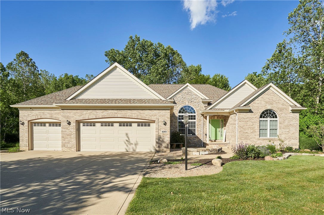 Discover the perfect blend of luxury and comfort in this stunning, expansive ranch located on a private .54-acre cul-de-sac lot. Featuring over 2,500 sq. ft. of main-level living space, this home boasts an open floor plan with high-volume ceilings, newer LVT flooring, and a chef’s dream cherry kitchen equipped with an island and double pantry. Relax in the sunroom overlooking the private backyard, or entertain on the Trex deck and paver patio. The finished lower level offers versatile space with a rec room, 4th bedroom/flex room, and a full bath. With a 3-car garage and meticulously designed interiors, this rare find offers truly effortless living. Open-concept layout with volume ceilings and stone gas fireplace. Master ensuite with tray ceiling, jetted tub, and walk-in closet. Chef's kitchen featuring a secretary desk, island, and abundant cabinetry.Finished lower level with garden windows and custom built-in bookshelves. This has a Private outdoor retreat with a sunroom, Trex deck, and paver patio. The roof was a tear off in 26 ,Insulated garage doors in 25, hotnwater tank approx 2019.