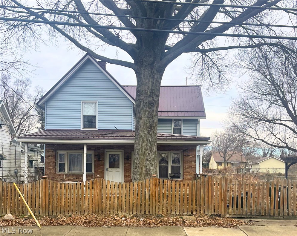 This 2 story, 2 bed, 2 bath frame built home sits on 2 parcels fully fenced in. The home has vinyl siding and a steel roof. The upper level has exterior only access, which needs repair. Being sold as-is with all appliances including 1st floor laundry. There is a full basement that has glass block windows, a newer forced air furnace and a water heater. The first floor has acoustic ceilings, wood cabinets in the kitchen, wood paneling and knotty pine in the den and kitchen and a ceiling fan in the den. The home features a full length covered porch and 45' x 20' 4 car garage with openers and concrete floor. There is access to the garage from both the street and alley.