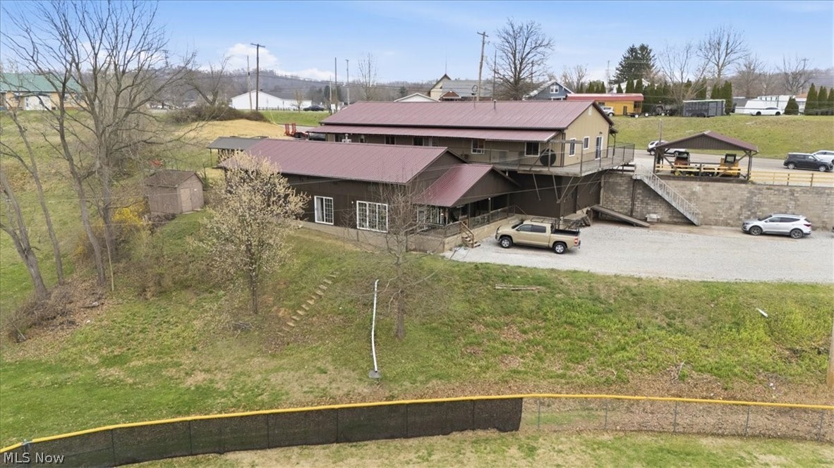 Don't miss out on the opportunity to own this Great Belpre, Ohio's multi purpose Property. Located on the High end of Washington BLVD overlooking the Ohio River and the Popular Civitan Park. Sitting on 1.5 acres are two buildings, building (1) has 6'400 sq/ft with 3,200 on the main level that could be used for retail, medical, office etc... The lower level shop has 3,200 sq/ft shop with two overhead garage doors and high ceilings that could serve many uses. Building (2) is over 2,000 sq/ft being used ase a 3 BR, 3 full bath home with a bonus room for either a play area or 4th BR. There is also a one bedroom 1 full bath efficiency apartment on the lower level with it's own entrance.
Additionally this property  has a very unique separate Cabin for quiet entertainment and enjoyment. There is  Plenty of parking for any need and the property is Zoned for commercial and residential use.