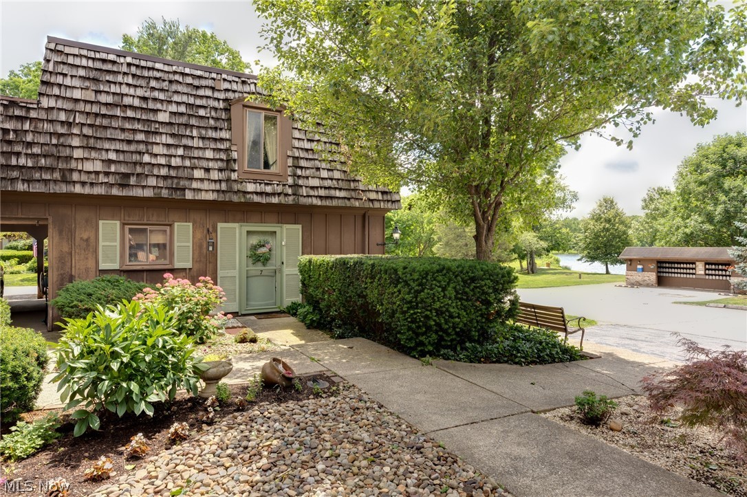 Enjoy gorgeous views of Granger Lake directly from your 1,440 sq. ft., 2-bedroom, 1.5-bath townhouse condo in the highly sought-after Highland Local School District. Perfectly positioned in the heart of the development, this home offers an ideal location...just steps from the mailboxes, yet away from the entrance and far-end traffic. Experience a sense of quiet luxury with everyday convenience. The slate floor entry opens to a spacious family room featuring a charming wood-burning fireplace. Sliding glass doors lead to a private patio overlooking the lake. The perfect place to relax and enjoy the peaceful setting. The kitchen offers newer cherry cabinetry, abundant storage, and all appliances stay. A conveniently located first-floor laundry room is just off the kitchen. Upstairs, you'll find two generously sized bedrooms, including an oversized primary bedroom. An expansive walk-in hall closet is large enough to serve as a dressing room. The spacious full bath, conveniently attached to primary bedroom, offers plenty of possibilities! A new stairlift (2025), which is negotiable with the home, provides added accessibility. Unlike many units, the carport, with its private locked storage area, is conveniently located just around the corner, making everyday access quick and easy. Enjoy lake privileges along with community amenities including pickleball/tennis courts and a clubhouse. The HOA covers water, sewer, trash, common area landscaping, and snow removal for exceptional low-maintenance living. The community is pet friendly. The roof was replaced in 2020 for added peace of mind. Conveniently located near shopping, dining, and major highways, this inviting condo offers comfort, convenience, and rare lake views in one exceptional package. Don't miss out on this rare opportunity!