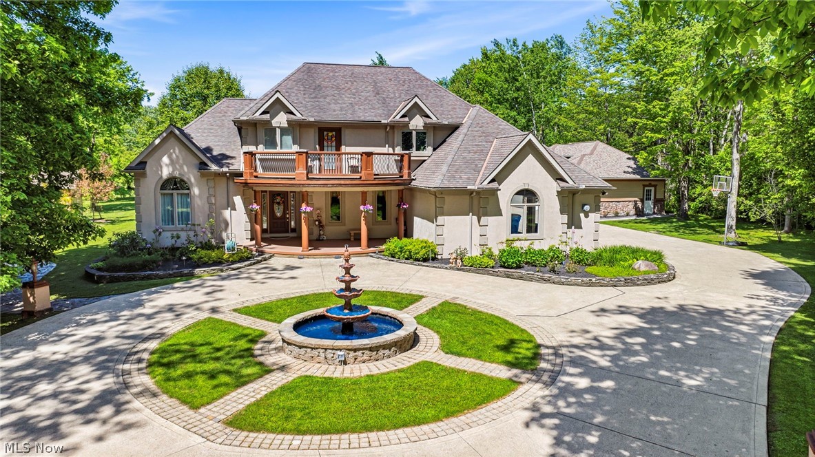 Welcome to 10600 Locust Grove Drive, a custom-built luxury estate in Chardon offering exceptional craftsmanship, elegant finishes, and incredible indoor and outdoor entertaining spaces. A grand foyer welcomes you into this stunning 4-bedroom, 4.5-bath home featuring Italian marble floors in the foyer, dining room, and kitchen. The main level showcases a dining room with a lighted tray ceiling, a spacious great room with vaulted ceilings and a stunning fireplace, a private office with French doors, and a luxurious first-floor owner's suite featuring a bay window, dual walk-in closets, and a Jacuzzi tub. Upstairs, two generous bedrooms share a full bath, while guests will enjoy a private suite with outdoor balcony access. The finished lower level is designed for ultimate relaxation and entertainment, boasting a full wet bar with new black granite countertops, a game room, home gym, theater with hidden speakers, hot tub room, sauna, and full bath. Step outside to a remarkable stone patio with two fire pits—one gas and one wood-burning—or retreat to the park-like side yard featuring a fountain, swing, and additional fire pit. Car enthusiasts and hobbyists will appreciate the attached three-car garage and the impressive 24x60 heated, detached three-car garage featuring EV charging, a floor drain, and a new epoxy floor, plus a 12x16 storage barn and a 12x10 storage shed. This one-of-a-kind property perfectly combines luxury, functionality, and resort-style amenities in a truly exceptional setting.