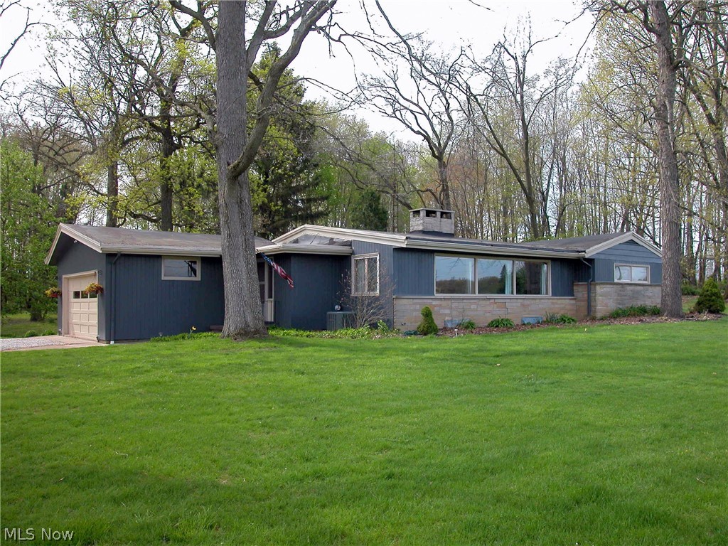 Craftman style Ranch home with many unique features on 3.64 acres. Enclosed Porch to back of home overlooking small creek and woods. Oversized Front windows in Living Room and Dining rooms with views of the countryside.  Vaulted, Beamed Ceilings, 2 -sided fireplace is open to the formal Living Room in the Front and the Family room to the back.  Full basement, 2 car garage, open floor plan, hardwood floors and much more.