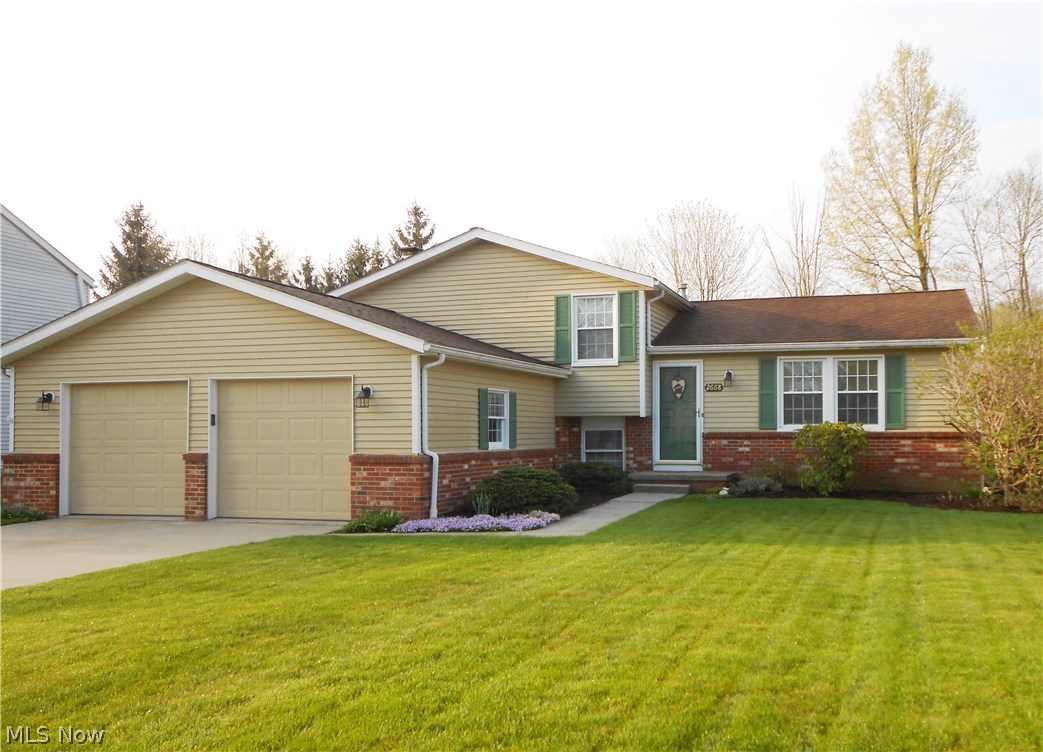 Pride of ownership shows in this beautiful, meticulous home!  Kitchen features custom Shrock cherry cabinets with pull out drawers, corian countertops, newer backsplash and breakfast bar.  The dining area is open to the kitchen and offers sliders to the 3 season sun room.  Outdoors you'll find a lovely brick patio and private backyard.  There’s even an electric retractable awning to shade you from the sun.  Both bathrooms have been recently updated.  The lower level features a family room with gas fireplace, a half bath and a bonus room currently being used as an office. The basement is partially finished offering you more options for additional living space.  This home also features newer windows and new living room/dining room carpeting (2016).  Looking for extra storage?  There’s a 2 ½ car garage PLUS a 24 x 25 outbuilding w/concrete floor and electric.. perfect for entertaining, storage, working on vehicles or any hobby your heart desires.  Home is close to park and hike/bike trail