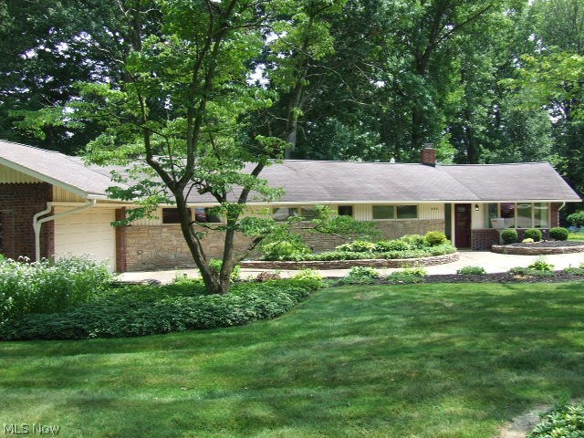 MID-CENTURY MODERN AT IT'S BEST!!  Want a house that is NOT cookie cutter, with lots of interesting history?  This is the house for you!!  Ranch with 3 bedrooms, 1 large, full bath with 2 sinks and linen closet, eat-in kitchen with appliances, including original wall oven with original manuals (plus a modern oven).  The large living room has cathedral ceiling, desirable and rare wormy chestnut paneling, woodburning brick fireplace and two walls of windows looking out at landscaped front yard and .783 acre backyard and stamped concrete patio.  There is a "bonus" room that could be a small office or craft room or simply additional storage.  Back of the house has first floor laundry/storage room that leads to the attached 2-car garage that was the original house.  This garage has several extra "rooms" or areas for even more storage.  In addition, at the back of the .783 acre is a 25x36 pole building with cement floor, electric, and 8-ft high garage door that could accommodate 6+ cars with