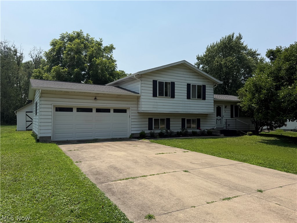 Well-maintained split-level home in the desirable Westvue Heights neighborhood of Tallmadge! This 3-bedroom, 1.5-bath home offers 1,576 square feet of living space on a beautiful nearly half-acre lot. Features include a spacious living room, eat-in kitchen, formal dining area, lower-level family room, hardwood floors in the bedrooms, attached 2-car garage, central air, public utilities, and a detached storage building. Enjoy the large backyard with plenty of room for entertaining or gardening. A wonderful opportunity to make this home your own