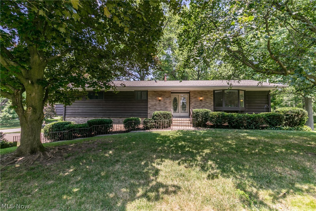 Welcome to this charming raised ranch that has over 2,000 sq ft of living space in Stow. Large family room with a beautiful bay window that allows for the sun to shine in. The living room also boasts a vaulted ceiling and an electric fireplace for those cold winter nights.  A sizeable kitchen with adjoining eating area, with tons of cupboards for storage, and also a nice island for sitting. From the kitchen step out to the enclosed three season room overlooking the backyard which makes a perfect spot for relaxing. There are 3 generously sized bedrooms and 2.5 baths. The master bedroom has an ensuite bathroom and walkout deck. The lower level of this home has a completed finished area, perfect for a kid’s rec room, man cave, or second living room and walks out to a covered porch and patio that is perfect for all your entertaining. Additional bonus to this great home is the fantastic 3 car garage and extra storage shed on this large wooded corner lot!