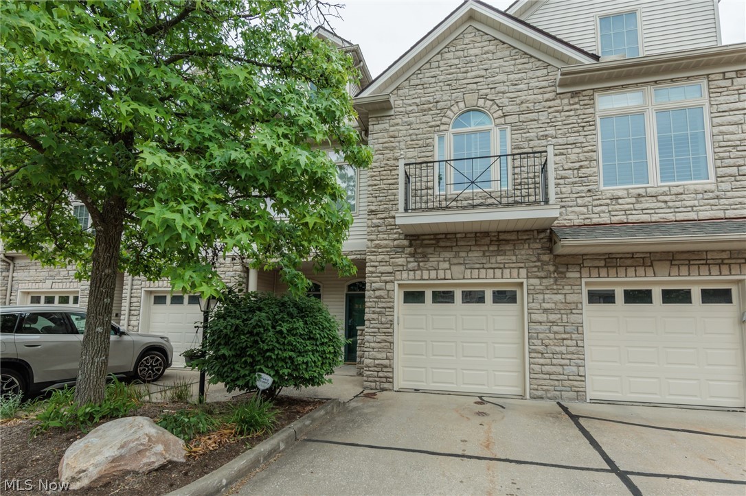 Welcome to Wedgewood Crossings! A condominium community in one of the best locations in Beachwood. Close to shopping, fine dining, aquatic center, walking trails, dog park, pickleball/tennis courts & more. Also close to major freeways. Beachwood has so much to offer its residences. And then there is the home. This beautiful spacious home has 2-bedrooms, 2 full baths with a loft/bedroom on the third floor. The kitchen has been updated to include a 4'5" x 6'5" island which includes base cabinets on 2 sides. Seating 6-8. Included in the updated kitchen is an additional storage cabinet along with additional counter and cabinet space. Abundant storage in the kitchen. Adjacent to the kitchen is the 2nd bedroom, along with a full bath and a separate laundry room. The adjacent living room / dining room offers soaring ceilings and a gas fireplace. Off the great room at the back of the home is a covered patio/balcony- great place to enjoy your morning coffee, glass of wine or a place to read a book or just listen to the rain. The Primary Suite offers spaciousness, a large walk-in closet & an updated primary bath. The 3rd floor is home to possibly a third bedroom/ office / exercise room, endless possibilities. Included on the 3rd floor is a storage area.  Pride of ownership throughout from the updated kitchen which includes granite countertops, backsplash, high-quality appliances, installation of an island & then there is the updated primary bath. The garage does have a bike lift. 
 This is your chance to enjoy low maintenance living, in one of Beachwood's prime locations and community. Please don't take my word for it, schedule your private tour today.