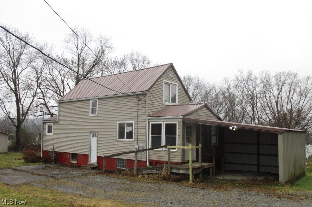 Vinyl sided 4 bedroom 2 story features a metal roof, spacious 2 car garage plus carport/storage shed located in a serene setting  convenient to all amenities.