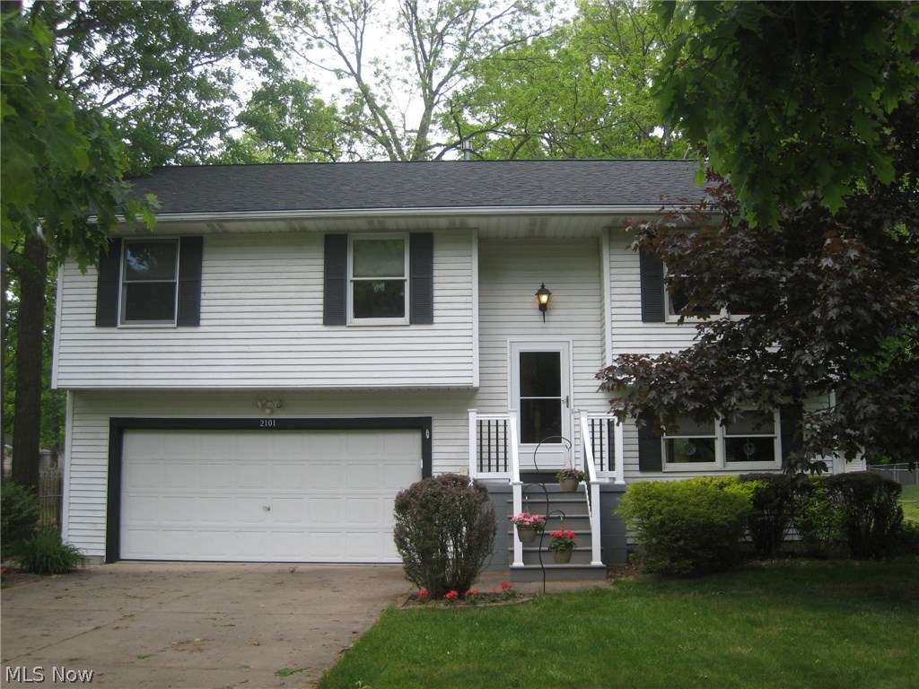 Wow!  Many updates make this home move in ready!   Cathedral ceilings enhance this spacious living, dining and kitchen area.  Beautiful Corian counter tops and ceramic backsplash, stainless steel appliances, pantry and great cabinet space make this a chef's dream.  The sliding glass door walks out to the upper deck that overlooks the fenced, landscaped and treed yard. There's a shed, too! A perfect area for entertaining inside and out.  Three good size bedrooms with closet organizers.  Updated bath also opens to the master bedroom.  The lower level features a recreation room which walks out to the lower deck.  An updated half bath, too.  Enter the oversized 2 car attached garage here.   Updates include:  Roof, furnace and central air 2012, stainless steel appliances, baths, ceiling fans and some lighting fixtures.  Carpets just cleaned throughout.  Beautiful!  Move in condition!