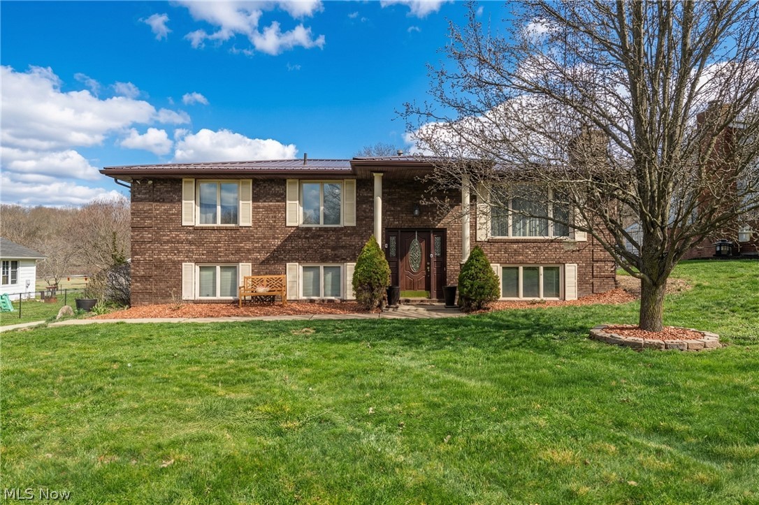 Welcome to this stunning all-brick bi-level, where classic durability meets modern sophistication on a beautifully landscaped 0.308-acre lot. From the moment you arrive, the manicured curb appeal and inviting curb appeal set the stage for a home that has been meticulously maintained inside and out. The interior transitions seamlessly from the spacious living room into a bright, updated kitchen featuring crisp white cabinetry, modern lighting, and appliances that stay for your convenience. Throughout the main level, you will appreciate the updated Anderson windows and newer flooring that enhance the home’s natural light and clean aesthetic. All three bedrooms are on the main level which includes a primary with private ensuite. The living space extends into a versatile walkout basement, anchored by a magnificent floor-to-ceiling brick fireplace and custom built-in shelving. This lower level, which includes a convenient half-bath, offers the perfect footprint for a cozy family room, a home office, or a private guest retreat. Outside, the backyard serves as a true outdoor oasis with a large deck and patio perfect for entertaining, while a dedicated storage shed provides extra room for your outdoor essentials. This home offers ultimate peace of mind with a host of major mechanical updates, including a brand-new roof, a new hot water tank, a 2018 furnace, and an AC unit replaced within the last decade. With three spacious bedrooms, two and a half baths, and an attached two-car garage, every detail has been handled so you can simply move in and enjoy. Call for a showing today before this home is sold!