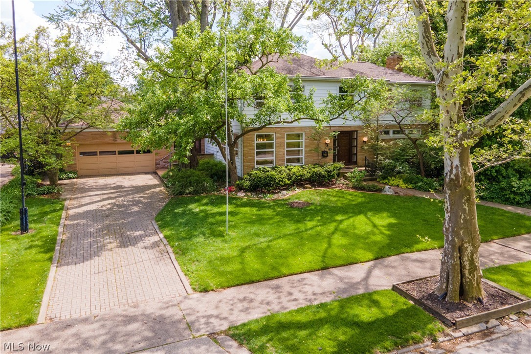 WOW! What a special home on one of the most charming streets in the Sandusky area. This one-owner contemporary home was inspired by Frank Lloyd Wright design, is stunning in current form but can easily be a modern masterpiece with the right cosmetic touches. Stunning rectangular windows throughout provide wonderful views of the tranquil and beautifully landscaped backyard with perennials galore and mature trees. Spacious living areas allow for wonderful entertainment spaces. The fully equipped kitchen could easily be opened to the living area. A fabulous attached 3 car garage with additional storage off the back and charming greenhouse to sustain any gardener through the winter. Upstairs, find 4 very nice sized bedrooms and two full bathroom. The master suite particularly is perfectly laid out with a glamour bath. Meticulously cared for and pride of ownership! Ample storage within the basement. Central vac! One won't find an opportunity like this everyday! Enjoy a sidewalk and treeline