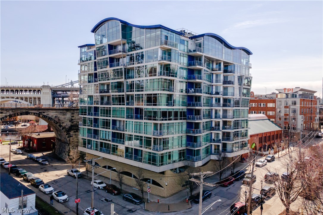 Welcome to the pinnacle of urban living—this stunning two-story penthouse in Cleveland’s highly sought-after The Plaza offers an unmatched blend of views and location.

Featuring 2 bedrooms and 2 full baths and 1,370 square feet of living, this exceptional residence is perched high above the city in the vibrant Flats district, showcasing dramatic architecture with soaring ceilings and expansive floor to ceiling windows that flood the space with natural light while framing breathtaking views of the Lake Erie and the Downtown skyline.

The open-concept main level is designed for both everyday comfort and elevated entertainment with a modern kitchen with granite countertops and stainless steel appliances. The kitchen is further enhanced by a new KitchenAid dishwasher (2025)—designed for ultra-quiet operation, creating a more peaceful and refined living experience.

Upstairs, retreat to your private owner’s suite oasis with spa-inspired finishes and direct access to your private rooftop deck—the perfect setting to unwind or entertain while taking in stunning sunsets and city lights. If you enjoy fireworks and air shows, you will have some of the best seats in town. A versatile loft space provides flexibility for a home office, lounge, or additional entertaining area.

This home has been thoughtfully updated with new carpet (2024) and a brand-new HVAC system installed in December 2024, offering improved energy efficiency and noticeably quieter performance for enhanced year-round comfort.

Additional highlights include two premium parking spaces in a prime location within the attached garage, an increasingly rare find in the area.
 
Come enjoy being just minutes from Ohio City, Tremont, Downtown Cleveland, and the Warehouse District. With award-winning dining, nightlife, and waterfront attractions at your doorstep, this is more than a home—it’s a lifestyle.