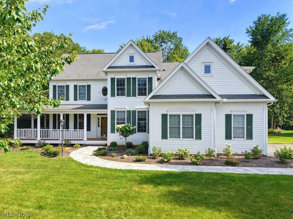 Love at first sight! A charming wraparound porch, thoughtfully designed landscaping, and a newly installed paver walkway create a welcoming first impression at this Laurel Springs colonial. Thoughtful improvements have transformed nearly every room, blending timeless architecture with a lighter, more current aesthetic. All the walls, trim, and ceilings have been professionally painted. Dated architectural columns have been removed to create cleaner sightlines and a more open floorplan, and new flooring extends through every room. Designer lighting and carefully selected wallpaper add personality in all the right places. Anchoring the main living spaces is a two story great room, where a wall of windows frames the wooded backdrop. The kitchen is timeless and functional, with Amish cabinetry, granite countertops, a center island, and a generous breakfast area. A 1st floor office or living room adds flexibility to the main level. The first floor primary suite has its own sitting room, fireplace, walk in closet and access to the patio. Upstairs, one bedroom has a private en suite, the other two share a Jack and Jill bath, and a bonus room great for a playroom or creative space. A cozy loft area and great closet space keep life beautifully organized. The lower level adds more flexibility with a large rec room, kitchenette, full bath, and a fifth bedroom or office. Outside, extensive brush and tree removal expanded the backyard while carefully preserving the wooded setting. A fantastic new patio replaced the old one, creating a huge outdoor space to unwind or entertain. The basement has been professionally waterproofed with a transferable warranty. The sellers thought of everything: the garage now has a taller overhead door and increased interior clearance for larger vehicles. Resort-style amenities in Ohio? Yes please! Laurel Springs residents enjoy a pool, clubhouse, tennis, volleyball, playground, and picnic pavilion, all just minutes to everywhere you want to be.